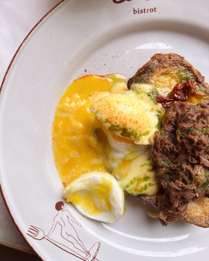 Delicious brunch dish featuring poached egg with beef on toasted bread.